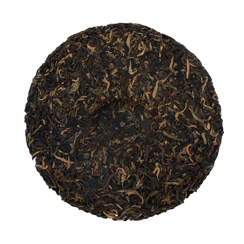 Round compressed tea cake on a white background