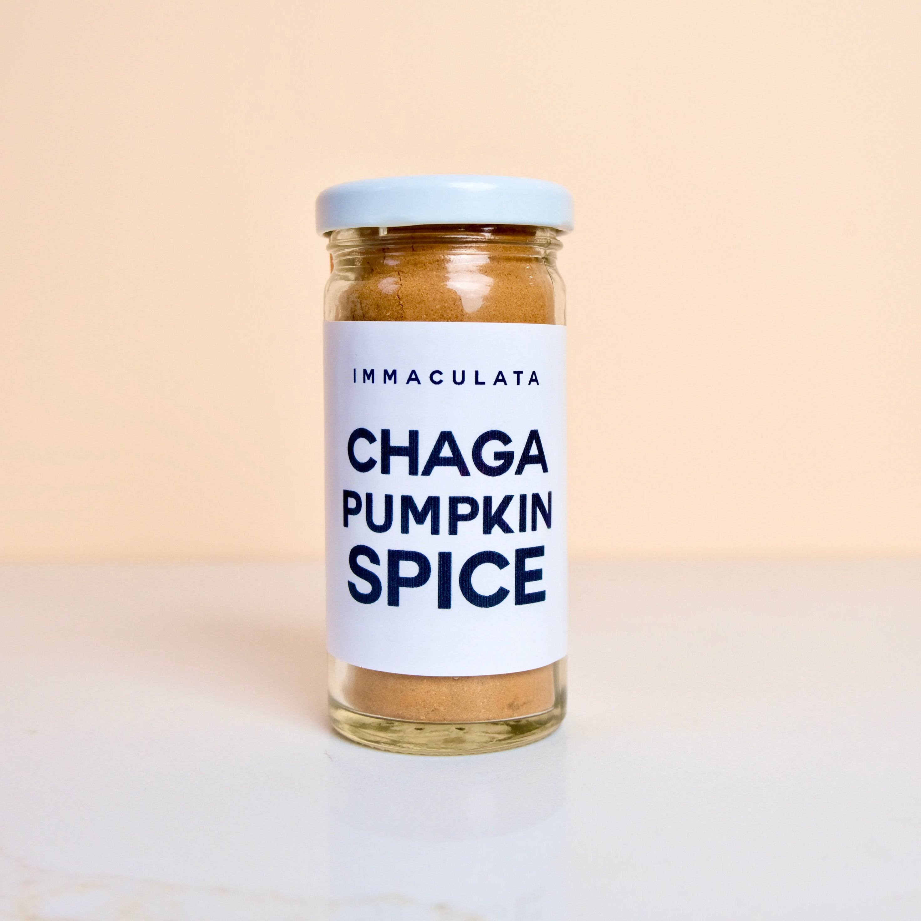 a jar of Immaculata Chaga Pumpkin Spice on a beige background