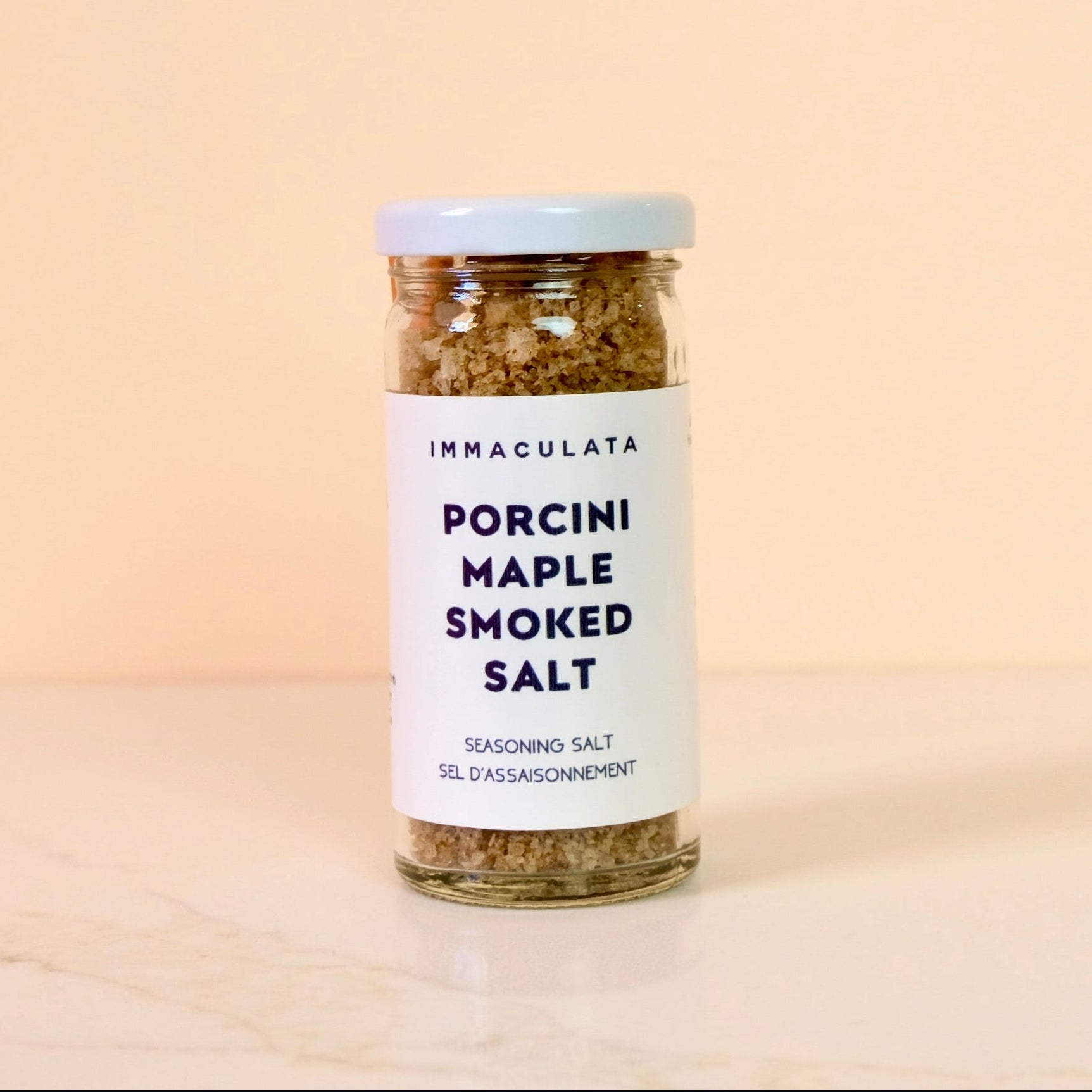 Jar of Immaculata Porcini Maple Smoked Salt on a beige background