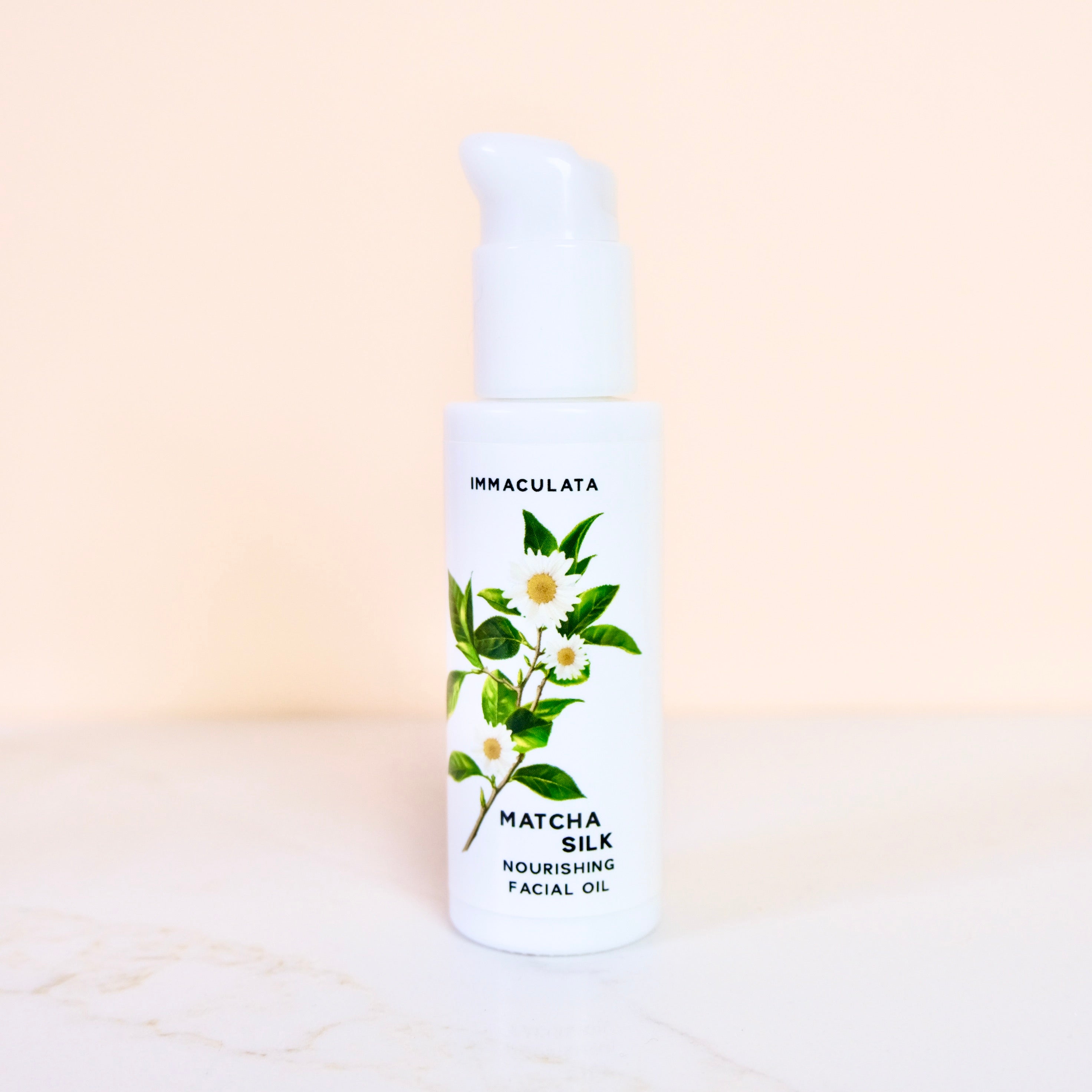 Bottle of Imaculata Matcha Silk Nourishing Facial Oil on a beige background