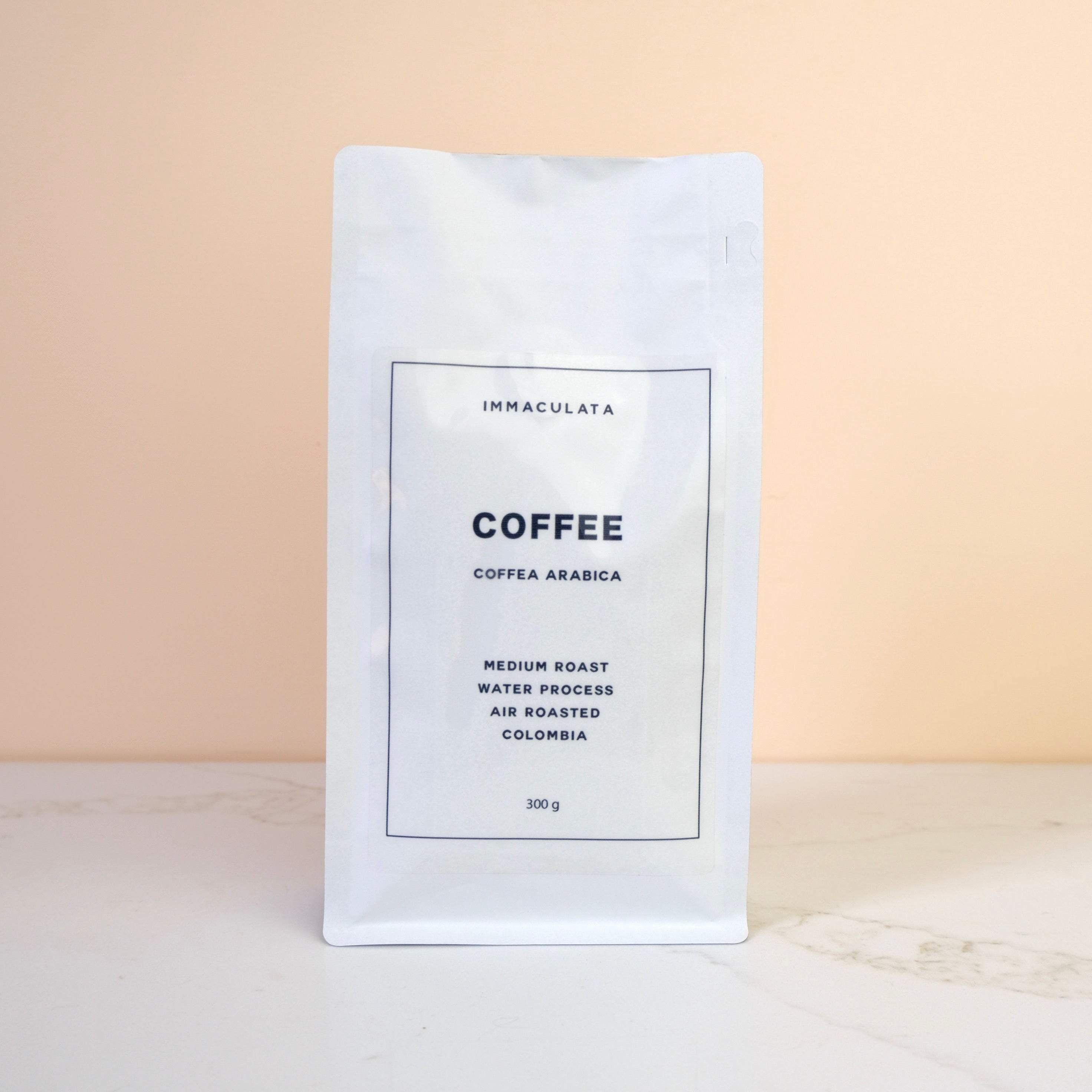 Coffee package with 'Immaculata' branding on a beige background
