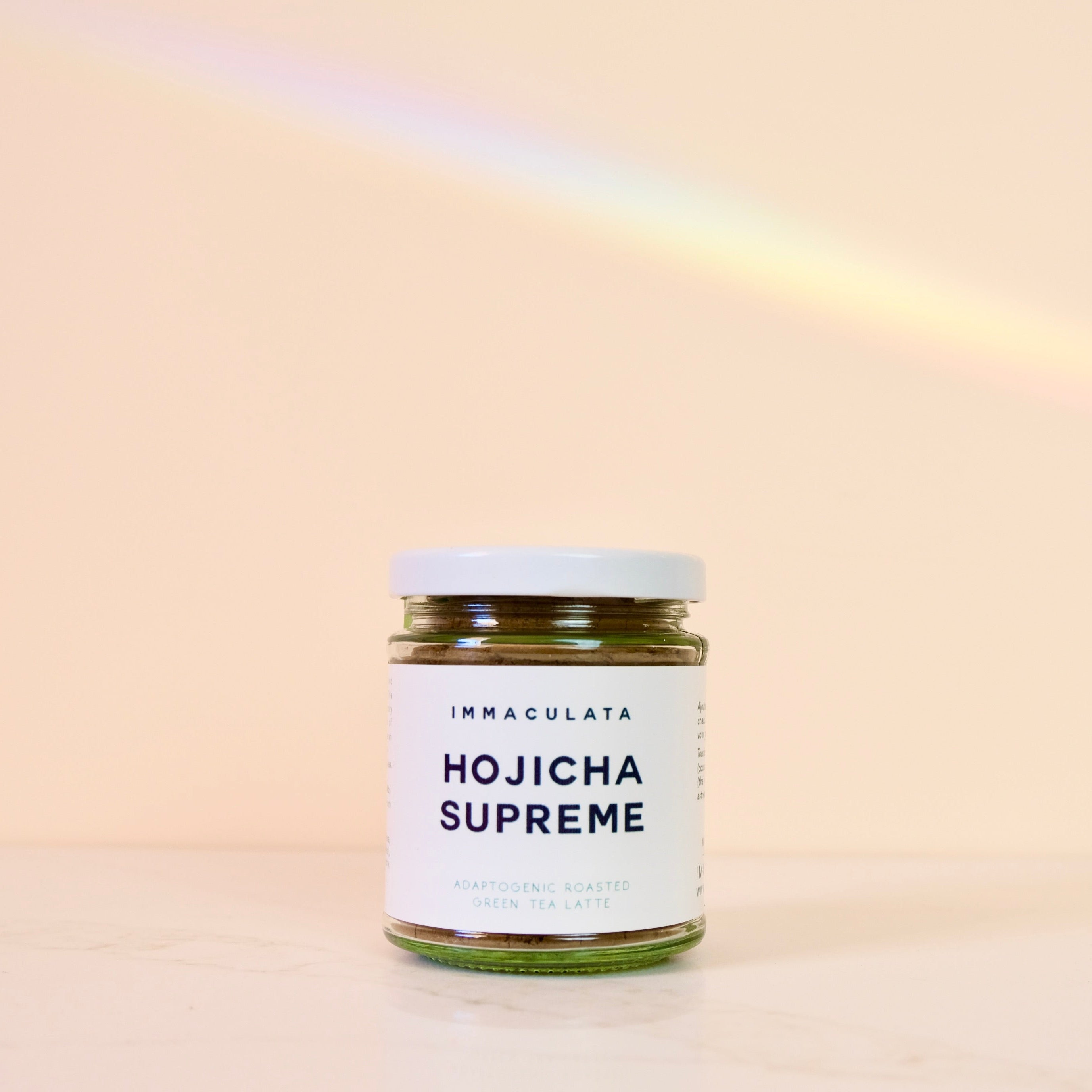 Jar of Hojicha Supreme with 'Immaculata' label on a beige background