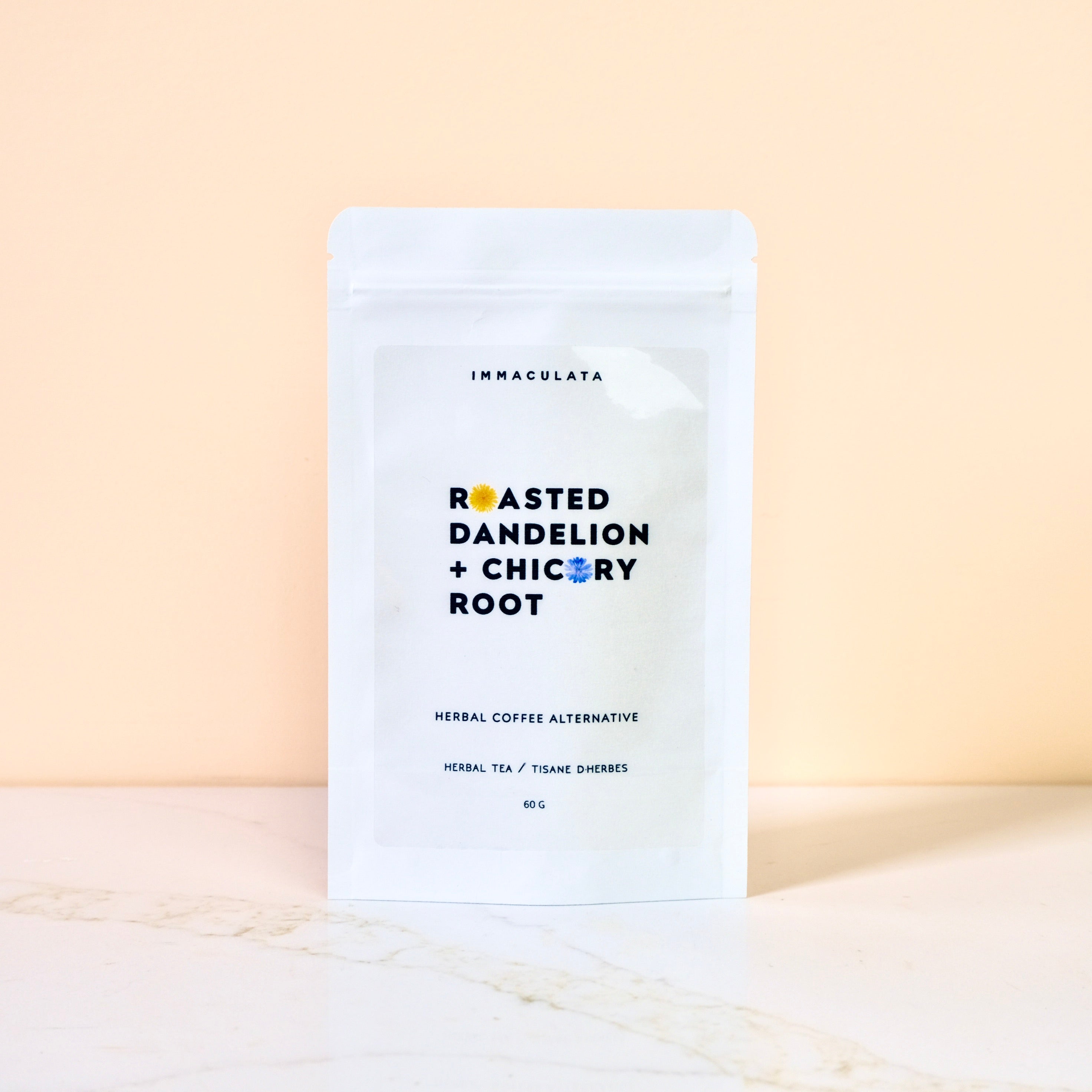 Tea package labeled 'Immaculata' with 'Roasted Dandelion + Chicory Root' on a light background
