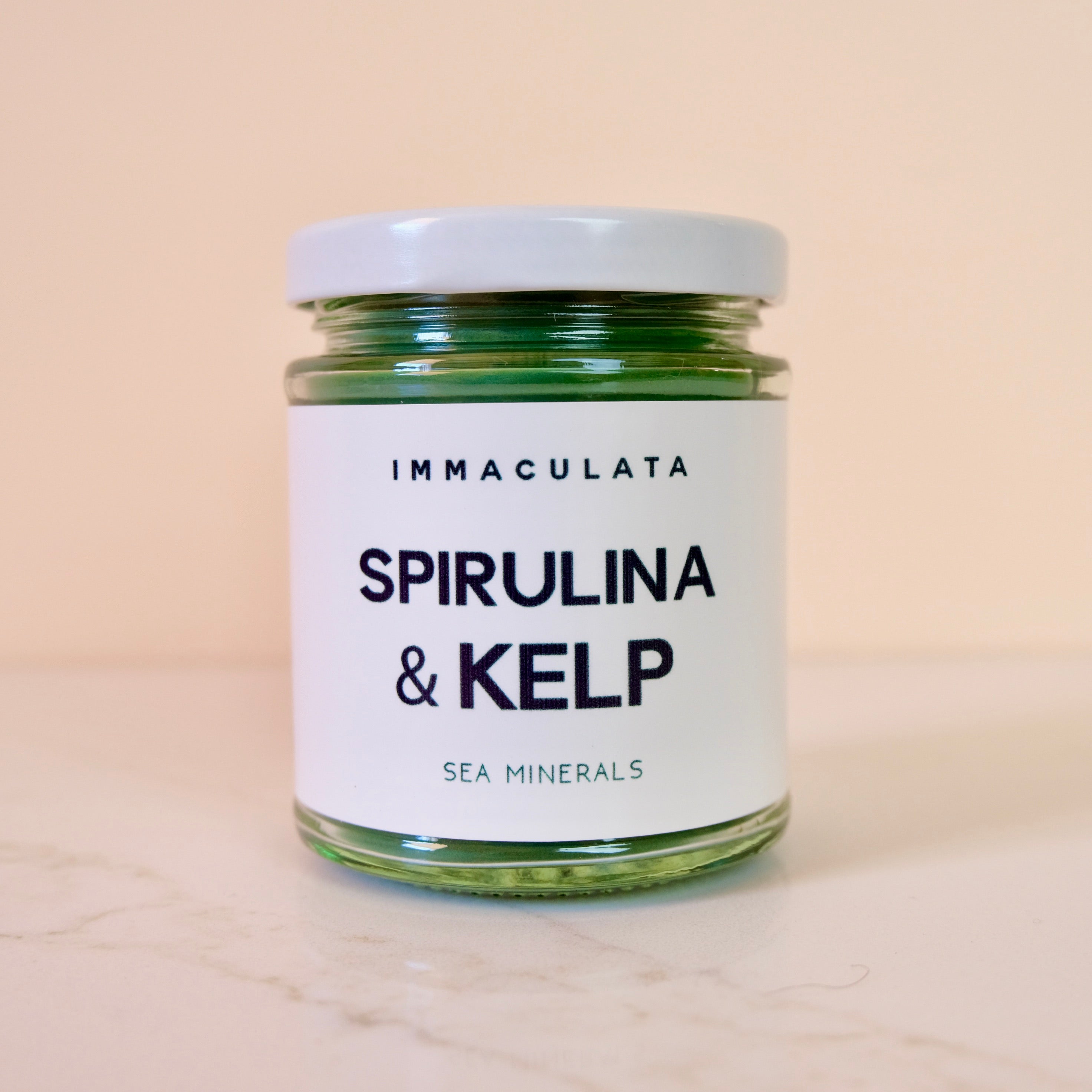 Jar of Spirulina & Kelp with 'Immaculata' label on a beige background