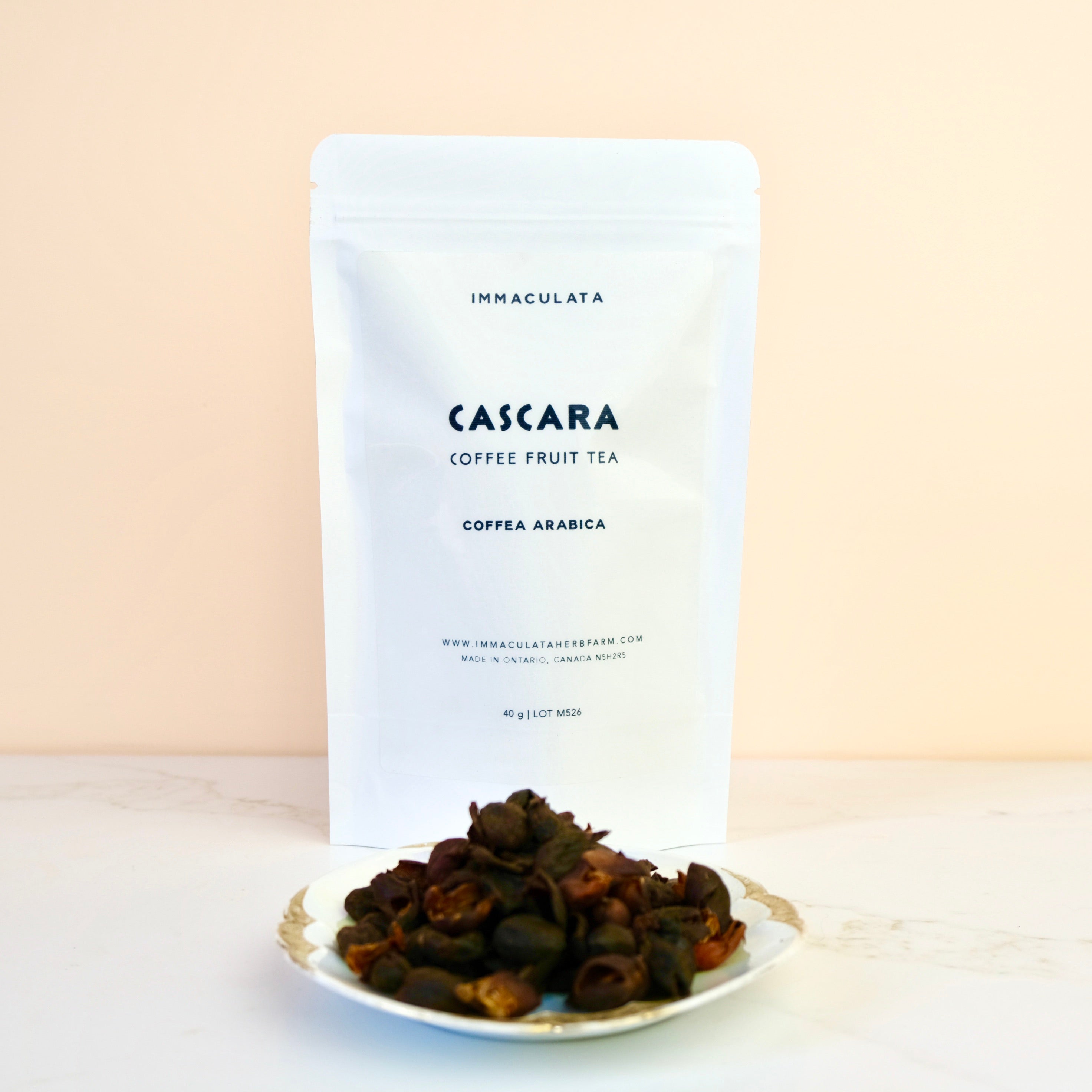 Cascara coffee fruit tea package with dried fruits on a plate against a beige background