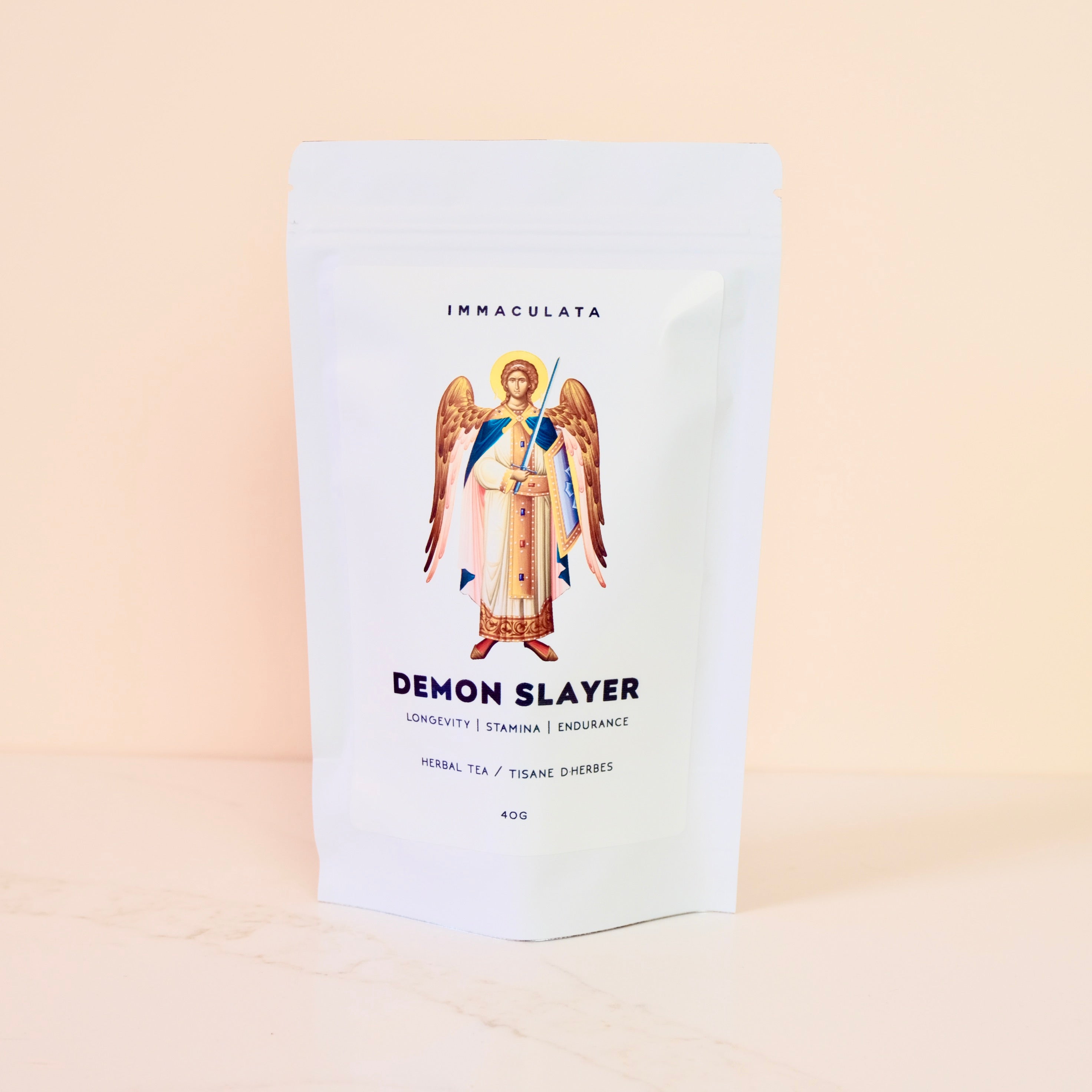 Tea package labeled 'Demon Slayer' with an angel illustration on a beige background