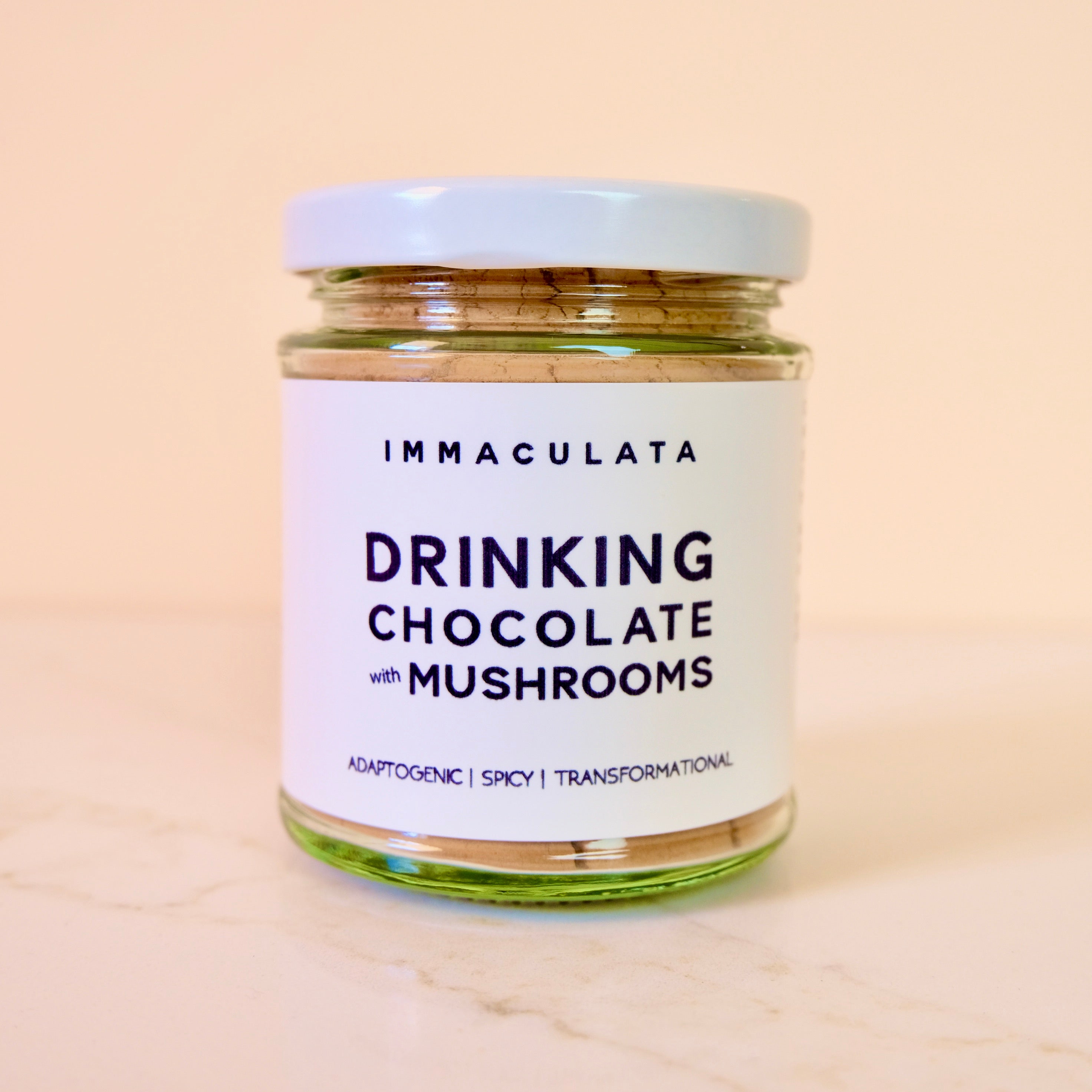 Jar of Immaculata Drinking Chocolate with Mushrooms on a beige background