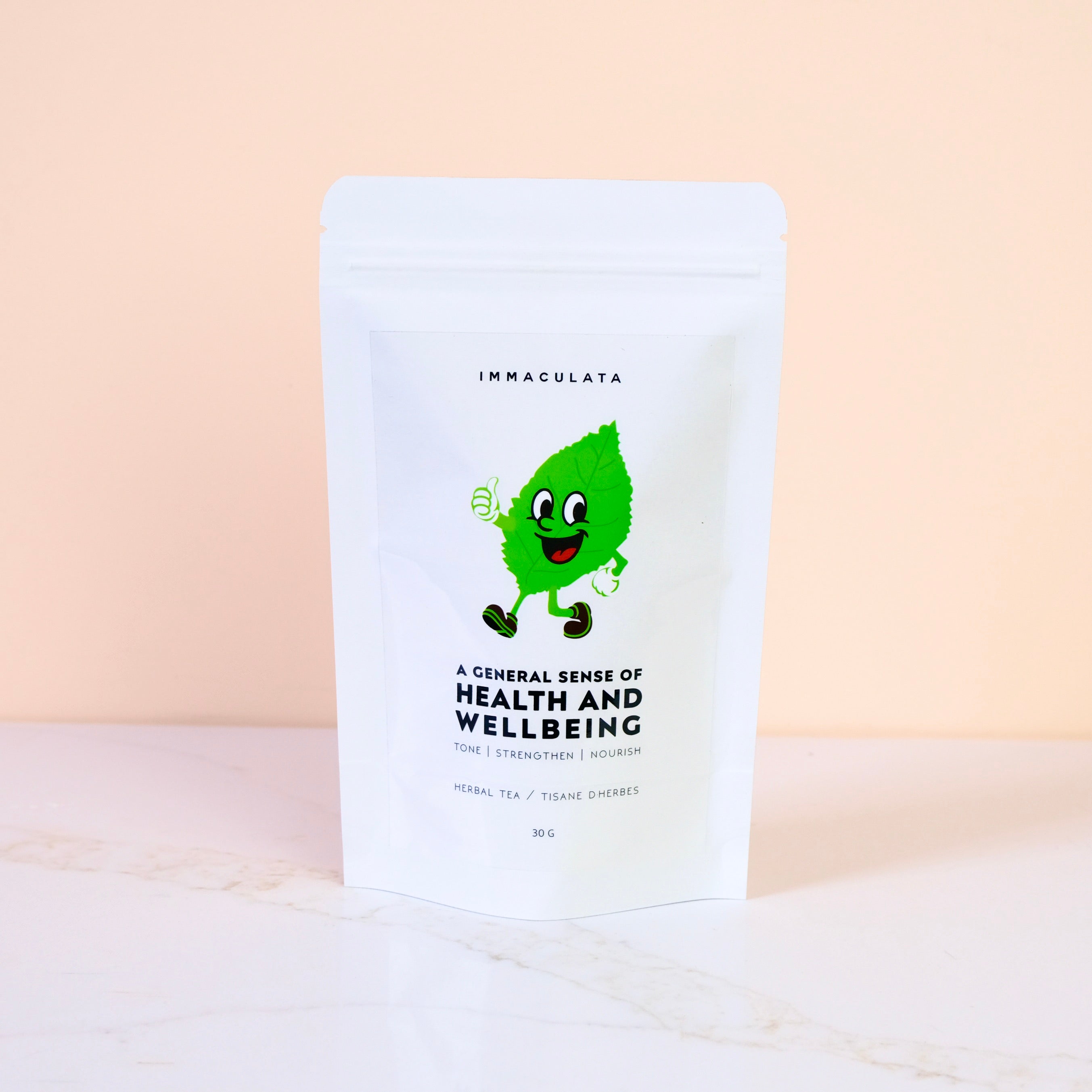 Tea bag packaging with a cartoon leaf character on a beige background