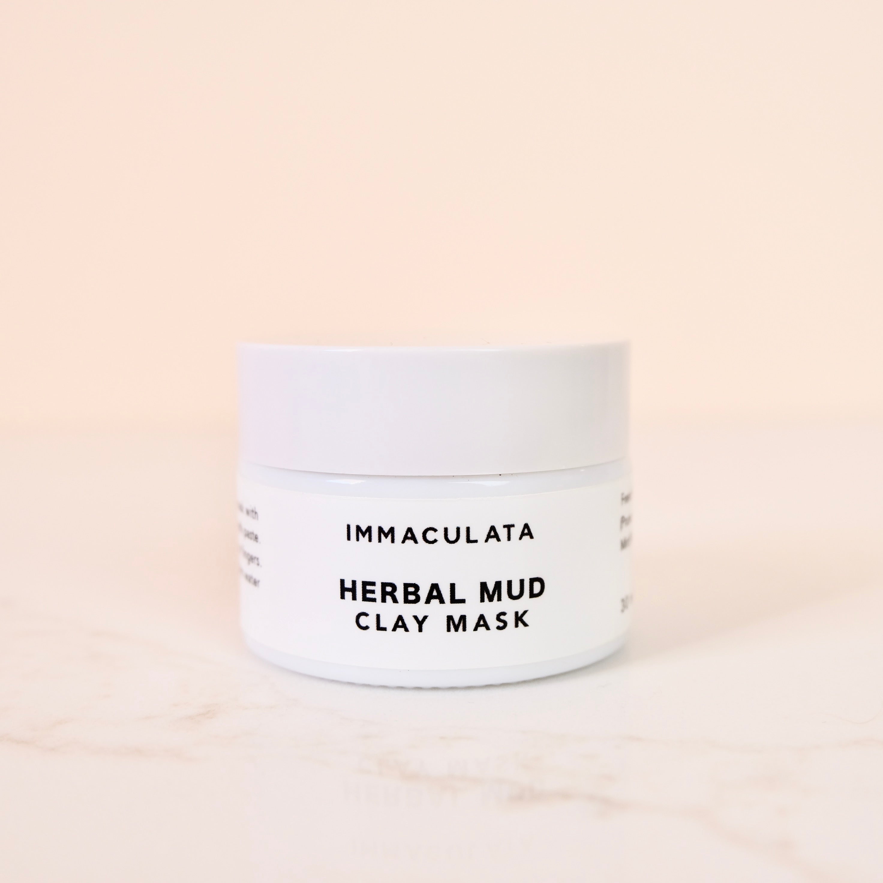 Jar of Immaculata Herbal Mud Clay Mask on a beige background