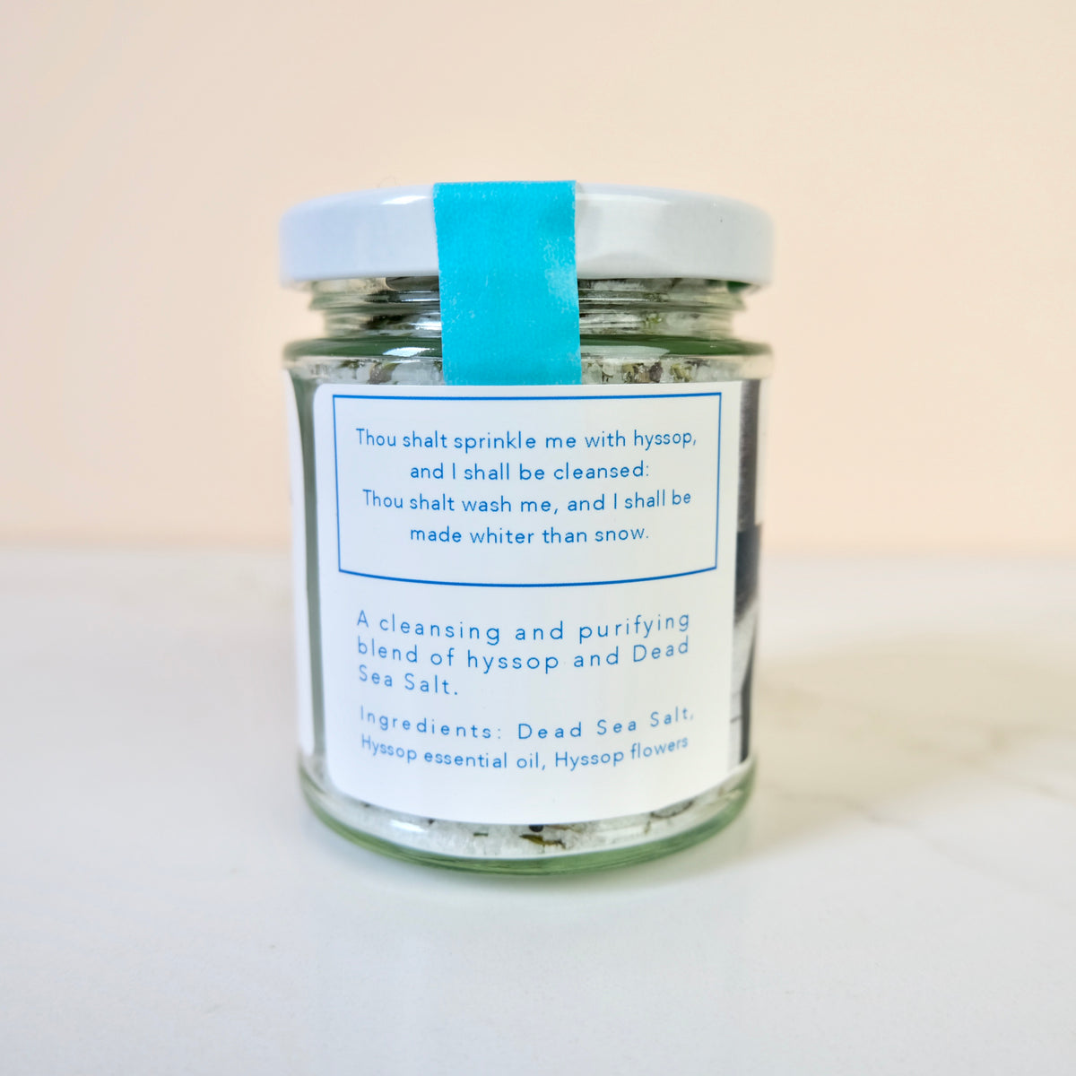 Glass jar with a label on a light background