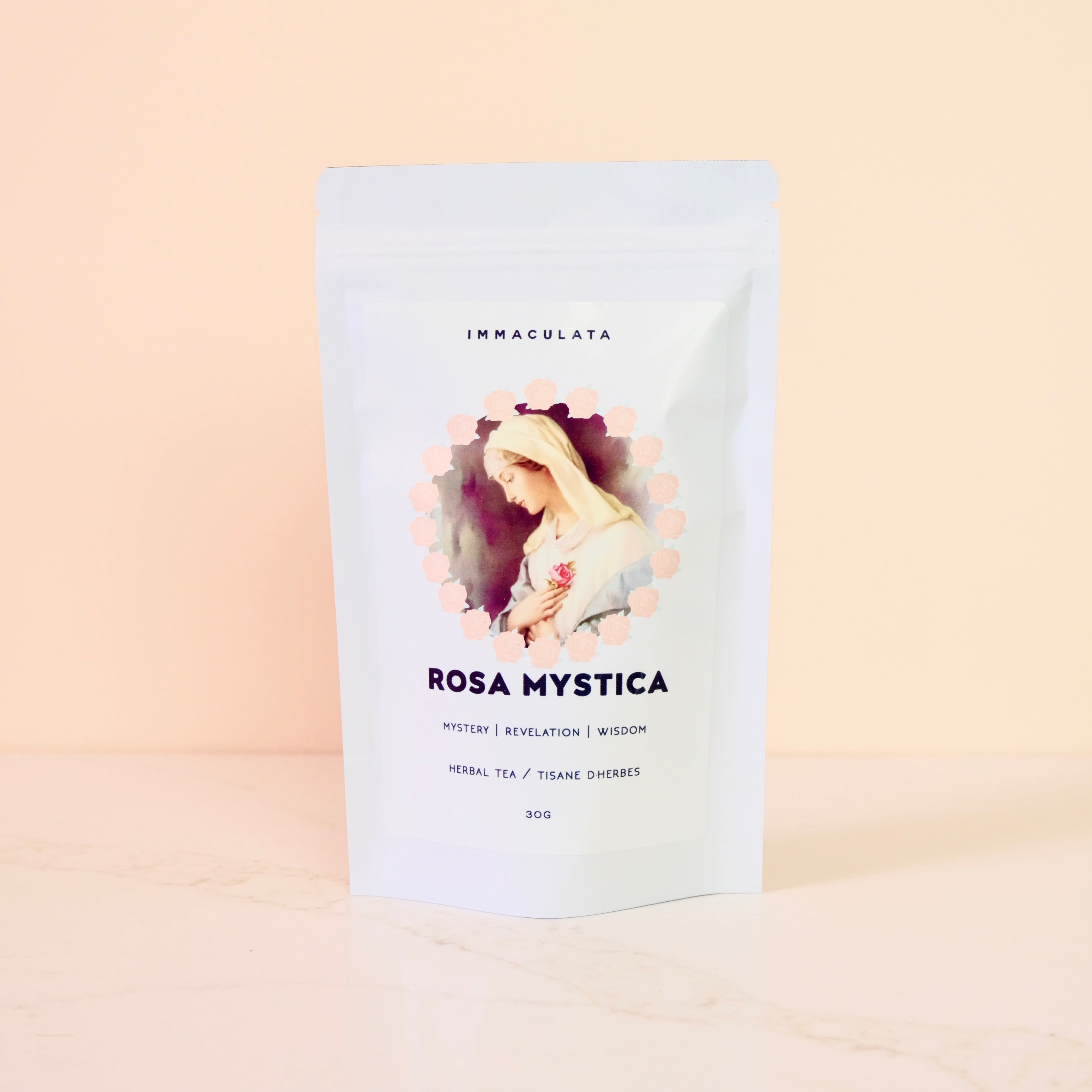 Tea package labeled 'Rosa Mystica' with a decorative design on a beige background