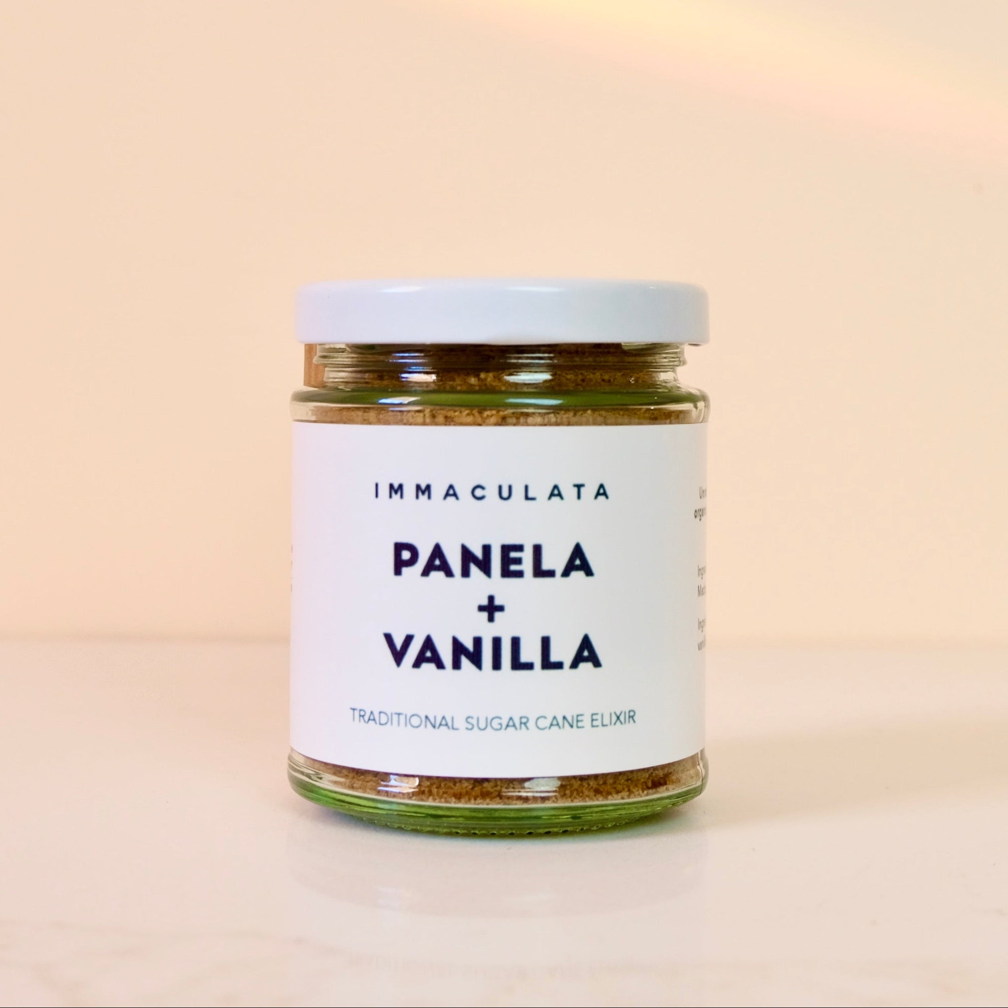 Jar of panela and vanilla on a beige background